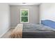 Simple bedroom features a window providing views and a comfortable bed at 7268 Loblolly Ln, Morrow, GA 30260