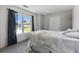 Well-lit bedroom with cozy bed, a large window, and stylish black curtains at 7268 Loblolly Ln, Morrow, GA 30260