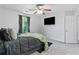 Comfortable bedroom featuring a flat-screen TV and large window with natural light at 7268 Loblolly Ln, Morrow, GA 30260