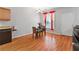 Bright dining area features hardwood floors, table, and window with red curtains at 7268 Loblolly Ln, Morrow, GA 30260