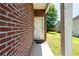 A white front door on a brick home, with a small concrete porch and well manicured lawn at 7268 Loblolly Ln, Morrow, GA 30260