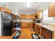 Functional kitchen with wood cabinets, black appliances and practical layout at 7268 Loblolly Ln, Morrow, GA 30260