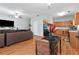 Open-concept living room and kitchen with hardwood floors and modern furniture at 7268 Loblolly Ln, Morrow, GA 30260