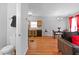 Living room with open view to kitchen, dining table, and a half bathroom at 7268 Loblolly Ln, Morrow, GA 30260