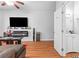 Bright living room with modern fireplace, TV, and an open view to a bathroom at 7268 Loblolly Ln, Morrow, GA 30260