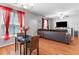 Open-concept living room with hardwood floors, TV, and large sofa at 7268 Loblolly Ln, Morrow, GA 30260