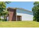 Side view of the house with a brick and vinyl exterior and a well-maintained lawn at 7268 Loblolly Ln, Morrow, GA 30260
