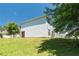 Home featuring a green lawn on the side, with vinyl siding, and a view of the surrounding residential neighborhood at 7268 Loblolly Ln, Morrow, GA 30260