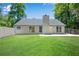 Back exterior view of a home with a new concrete patio and fenced yard at 8592 Hidden Creek Cir, Snellville, GA 30039