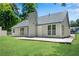 Back exterior featuring new siding, a concrete patio, and a fenced in yard at 8592 Hidden Creek Cir, Snellville, GA 30039