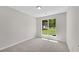 Sunlit bedroom with large window overlooking the yard at 8592 Hidden Creek Cir, Snellville, GA 30039