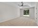 Spacious bedroom with plush carpeting, trey ceiling, and large window bringing in natural light at 8592 Hidden Creek Cir, Snellville, GA 30039
