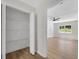 Open closet area flowing into a bedroom with hardwood floors and natural light at 8592 Hidden Creek Cir, Snellville, GA 30039