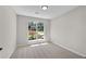 Bright bedroom with large window view, carpeting, and neutral paint at 8592 Hidden Creek Cir, Snellville, GA 30039