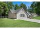 Charming single-Gathering home with manicured lawn, grey siding, asphalt shingles, and bright white trim at 8592 Hidden Creek Cir, Snellville, GA 30039