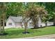 Well-maintained single-Gathering home with a manicured lawn, grey siding, and mature trees at 8592 Hidden Creek Cir, Snellville, GA 30039