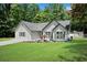 Well-maintained single-Gathering home with manicured lawn, grey siding, new roof, and beautiful landscaping at 8592 Hidden Creek Cir, Snellville, GA 30039