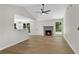 Bright open-plan living room showcasing hardwood floors, a cozy fireplace, and a vaulted ceiling at 8592 Hidden Creek Cir, Snellville, GA 30039