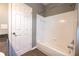 Bathroom featuring white shower-tub combo with white tile surround and a neutral paint at 122 Summer Pl, Norcross, GA 30071