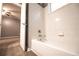 Bathroom featuring white shower-tub combo with white tile surround and a neutral paint at 122 Summer Pl, Norcross, GA 30071