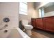 Bathroom showcasing a bathtub, toilet, and vanity with a dark countertop at 122 Summer Pl, Norcross, GA 30071