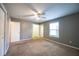 Spacious bedroom with carpet, ceiling fan, closets, and a window with natural light at 122 Summer Pl, Norcross, GA 30071