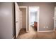 View into closet adjacent to bathroom featuring white shelving and a neutral paint at 122 Summer Pl, Norcross, GA 30071