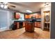 Well-lit kitchen featuring a central island and classic wood cabinets at 122 Summer Pl, Norcross, GA 30071