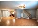 Open-concept living area with tile floors and stairs leading to the second level, perfect for modern living and entertaining at 122 Summer Pl, Norcross, GA 30071