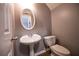Cozy half-bathroom featuring a pedestal sink and efficient toilet at 122 Summer Pl, Norcross, GA 30071