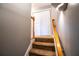 Carpeted stairs with wood railing that add a warm touch and lead to the upper level of the house at 122 Summer Pl, Norcross, GA 30071