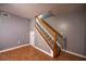 Carpeted stairs with white and wood railing that add a warm touch and lead to the upper level of the house at 122 Summer Pl, Norcross, GA 30071