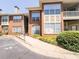 Brick condo building exterior featuring a reserved parking spot and well-maintained landscaping at 200 Renaissance Ne Pkwy # 310, Atlanta, GA 30308