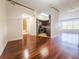 Open layout with hardwood floors connecting the living space, kitchen, and bathroom at 200 Renaissance Ne Pkwy # 310, Atlanta, GA 30308