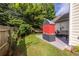 Landscaped backyard features a built-in grill, patio, hammock and lush greenery at 2092 Wood Nw Trl, Atlanta, GA 30318