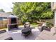 Outdoor patio featuring a built-in grill, comfortable seating, and a relaxing hammock under mature trees at 2092 Wood Nw Trl, Atlanta, GA 30318
