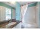 Bright bathroom featuring a tub-shower combo with a white curtain and rainbow wallpaper at 2092 Wood Nw Trl, Atlanta, GA 30318