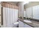 Clean bathroom with granite countertop, shower and white cabinets at 2092 Wood Nw Trl, Atlanta, GA 30318