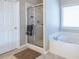 Bathroom with glass shower, soaking tub, and tile flooring at 2092 Wood Nw Trl, Atlanta, GA 30318