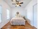 Bedroom features hardwood floors, ceiling fan, and plenty of natural light at 2092 Wood Nw Trl, Atlanta, GA 30318