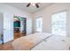 Bright bedroom with hardwood floors, ceiling fan, and double doors to a dining room at 2092 Wood Nw Trl, Atlanta, GA 30318