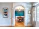 View of formal dining room through arched entryway with white columns and hardwood floors at 2092 Wood Nw Trl, Atlanta, GA 30318