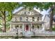 Charming two-story home with a classic white picket fence and inviting front porch nestled among mature trees at 2092 Wood Nw Trl, Atlanta, GA 30318