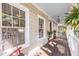 Inviting front porch with swing, wood floors, and decor creating a warm and welcoming entrance at 2092 Wood Nw Trl, Atlanta, GA 30318