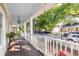 Relaxing front porch with a swing overlooking the street, creating a welcoming and comfortable outdoor space at 2092 Wood Nw Trl, Atlanta, GA 30318