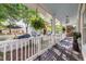 Spacious front porch with a swing, hanging ferns, and views of the charming neighborhood street at 2092 Wood Nw Trl, Atlanta, GA 30318