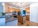 Well-lit kitchen with granite countertops, stainless steel appliances, wood cabinets and functional center island at 2092 Wood Nw Trl, Atlanta, GA 30318