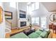 Bright living room with a cozy fireplace, large windows, and hardwood floors creating an inviting space at 2092 Wood Nw Trl, Atlanta, GA 30318