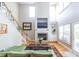 Living room features a fireplace, large windows, and a vaulted ceiling at 2092 Wood Nw Trl, Atlanta, GA 30318