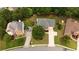 Aerial view showcasing a well-maintained property with ample parking and a lush, green surroundings at 285 Finsbury Park Ct, Suwanee, GA 30024